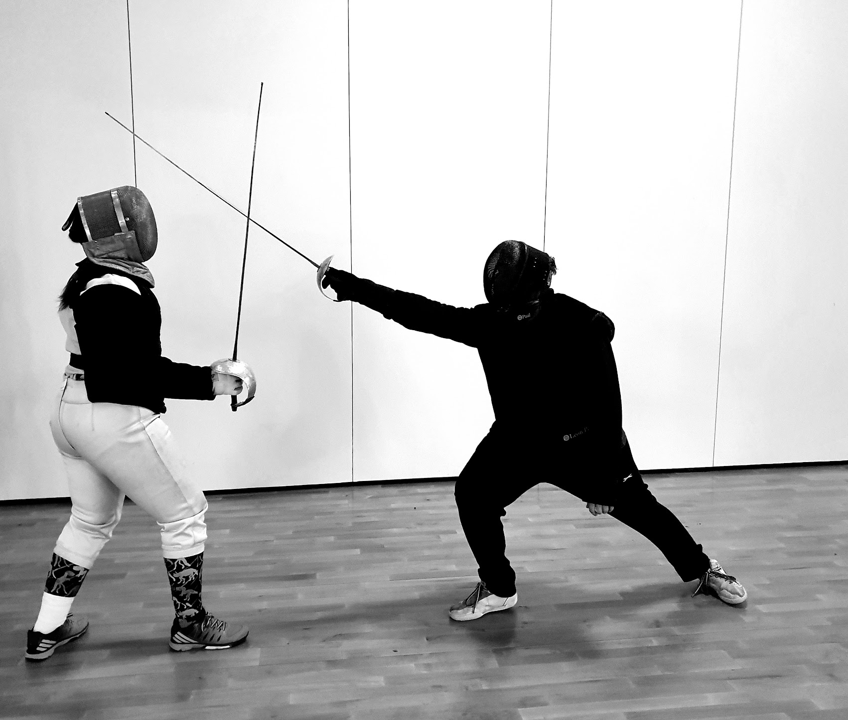 A British Academy of Fencing coach teaching a pupil