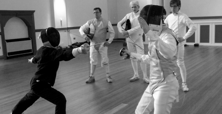 A group of fencers receiving training in coach development