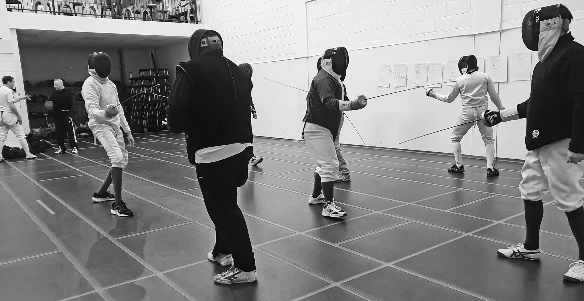 A group of fencers receiving coach training